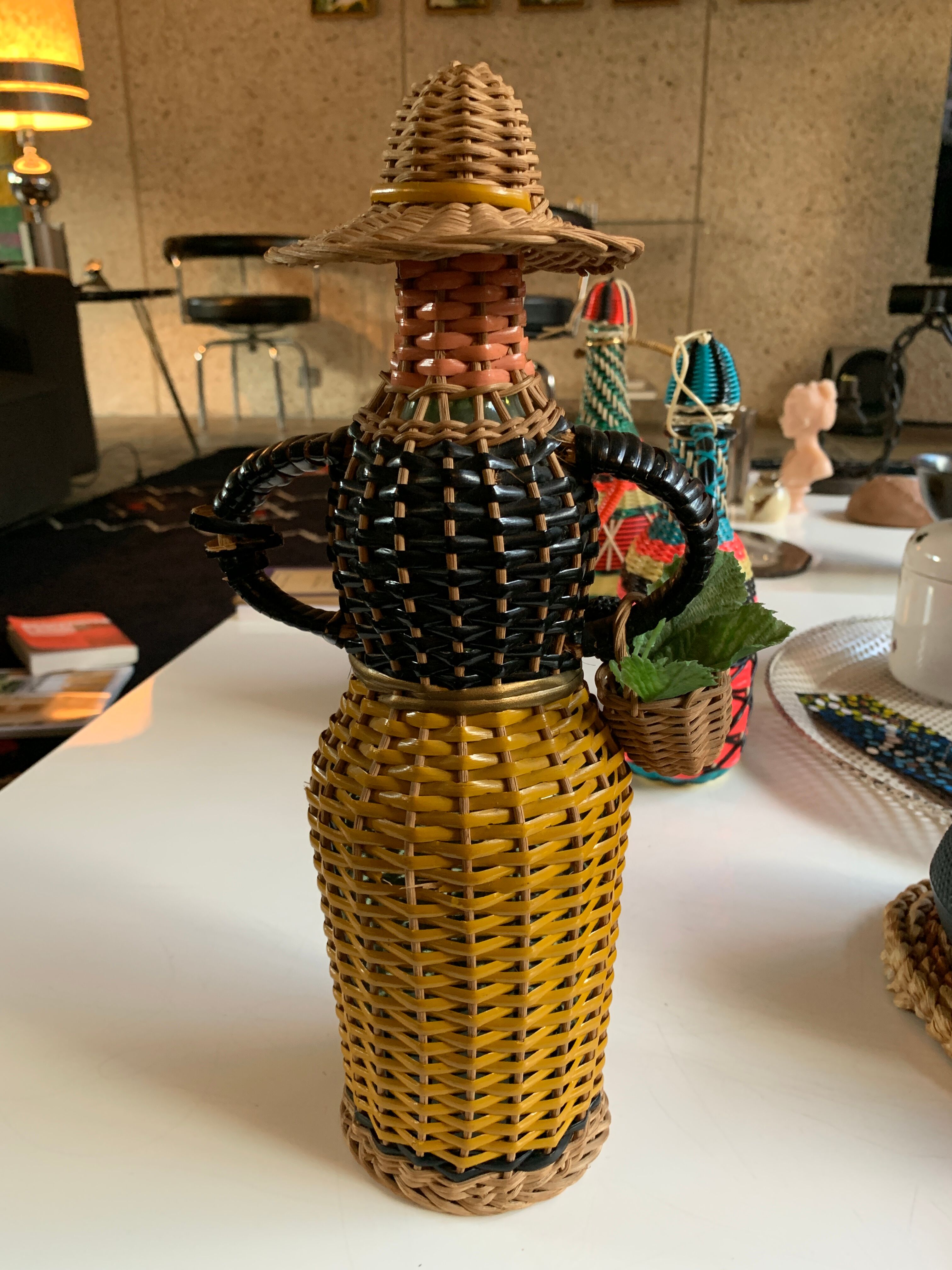 Braided bottle in anthropomorphic wicker