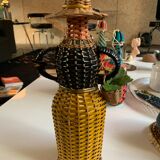 Braided bottle in anthropomorphic wicker