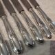 12 silver-plated metal table knives with rocaille ribbon decoration, 25.1 cm