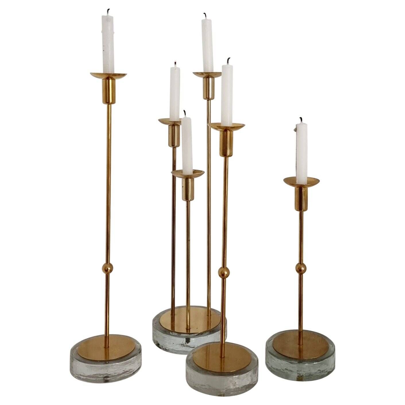 Gunnar Ander, four candlesticks, brass and glass, Ystad Metall, Swedish modern.