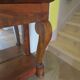 Empire/Restoration style console table with scrolled ends, mirrored back, and claw feet.