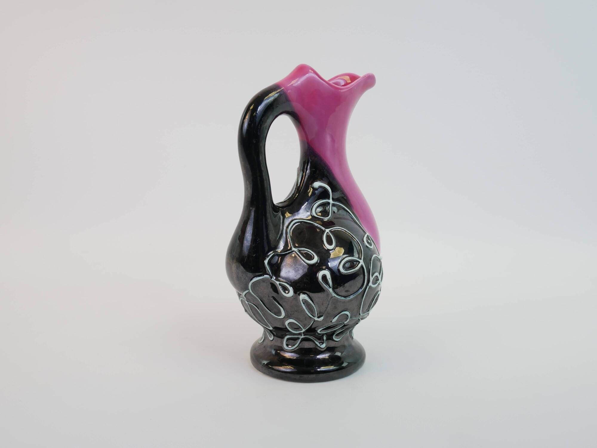 Black and pink Vallauris carafe with white relief patterns