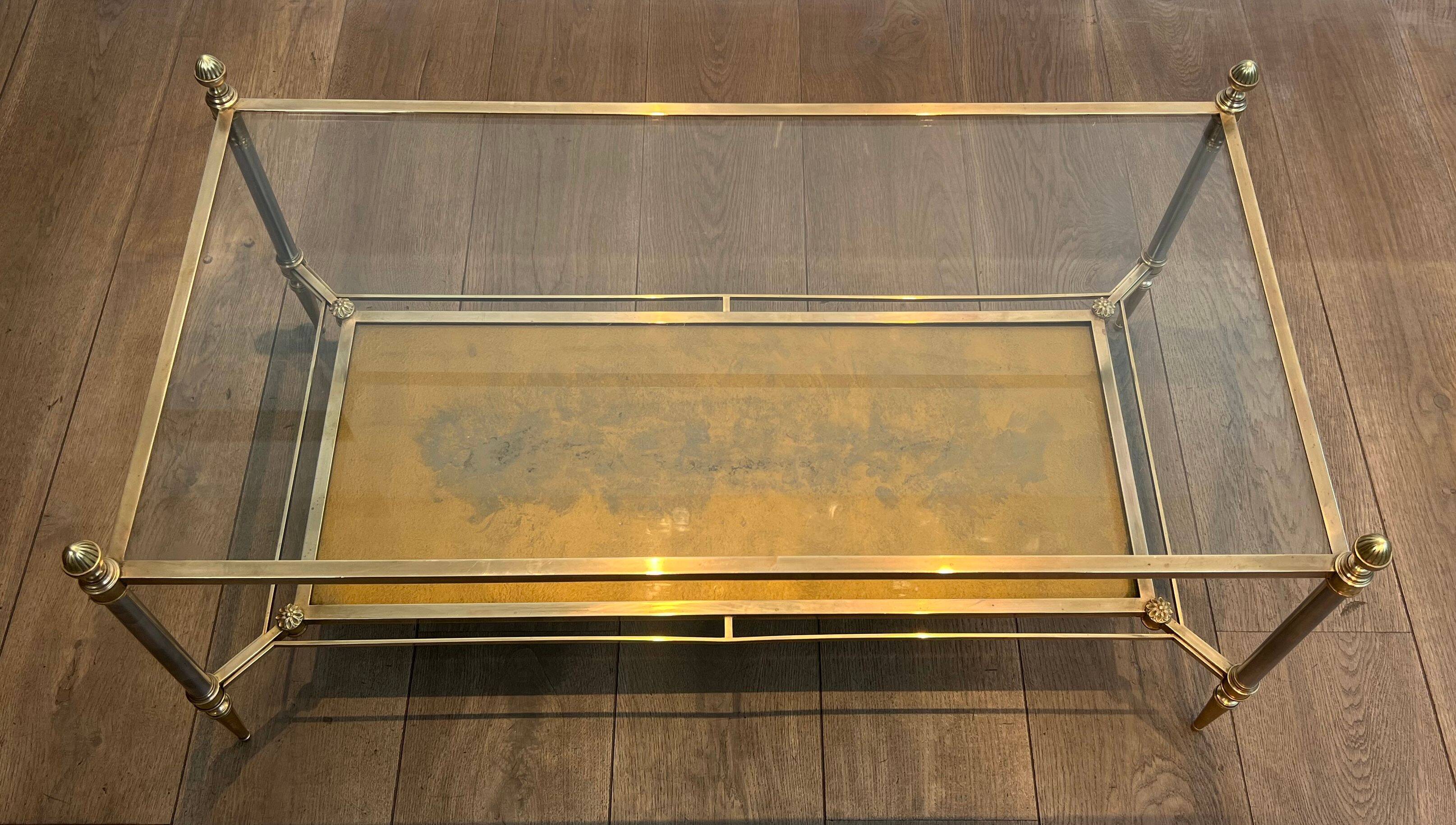 Coffee table in brass, brushed steel, glass, and gilded eglomisé mirror from Maison Jansen.