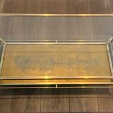 Coffee table in brass, brushed steel, glass, and gilded eglomisé mirror from Maison Jansen.