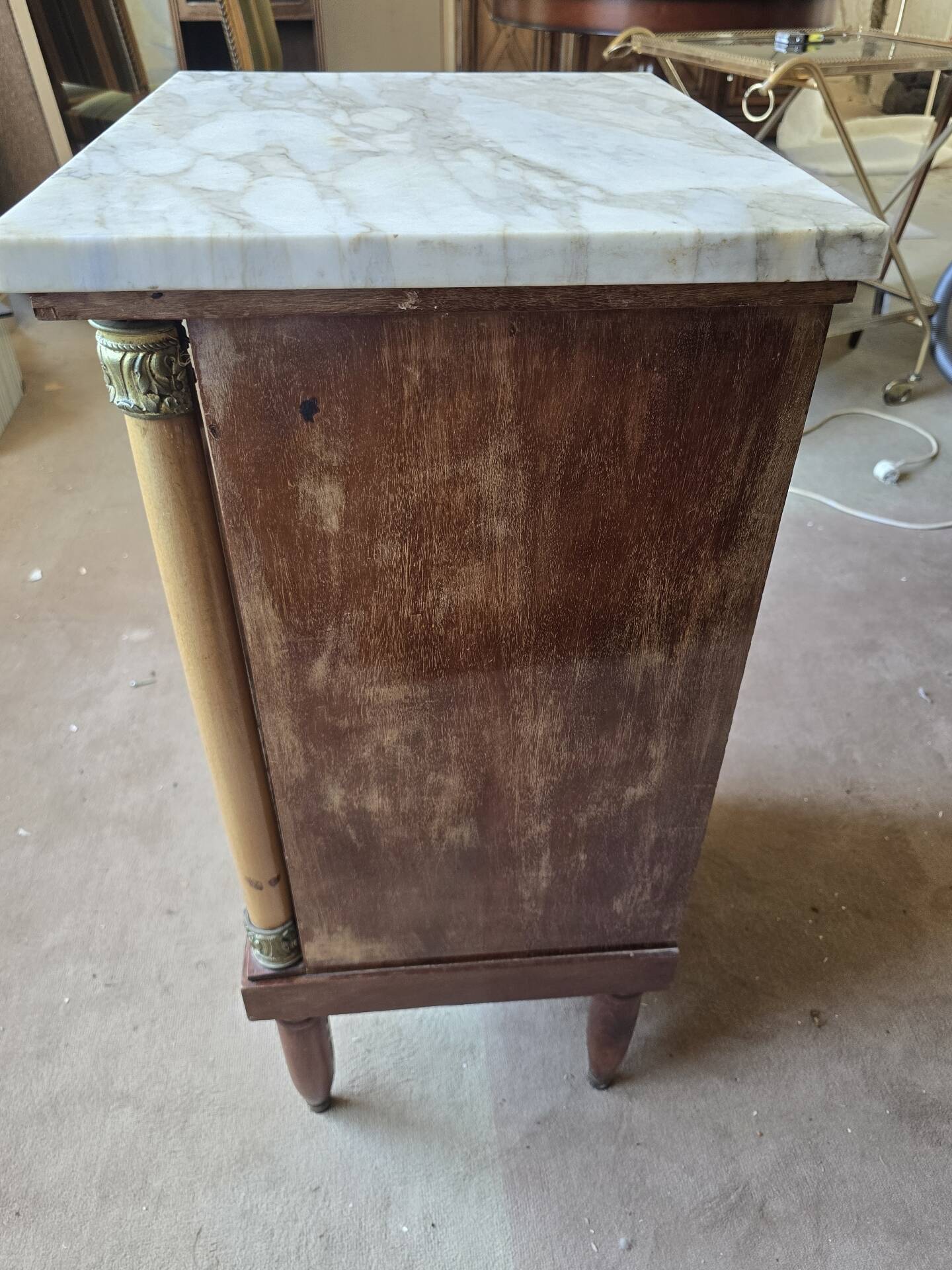 Antique Empire-style bedside table with marble top.