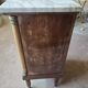 Antique Empire-style bedside table with marble top.