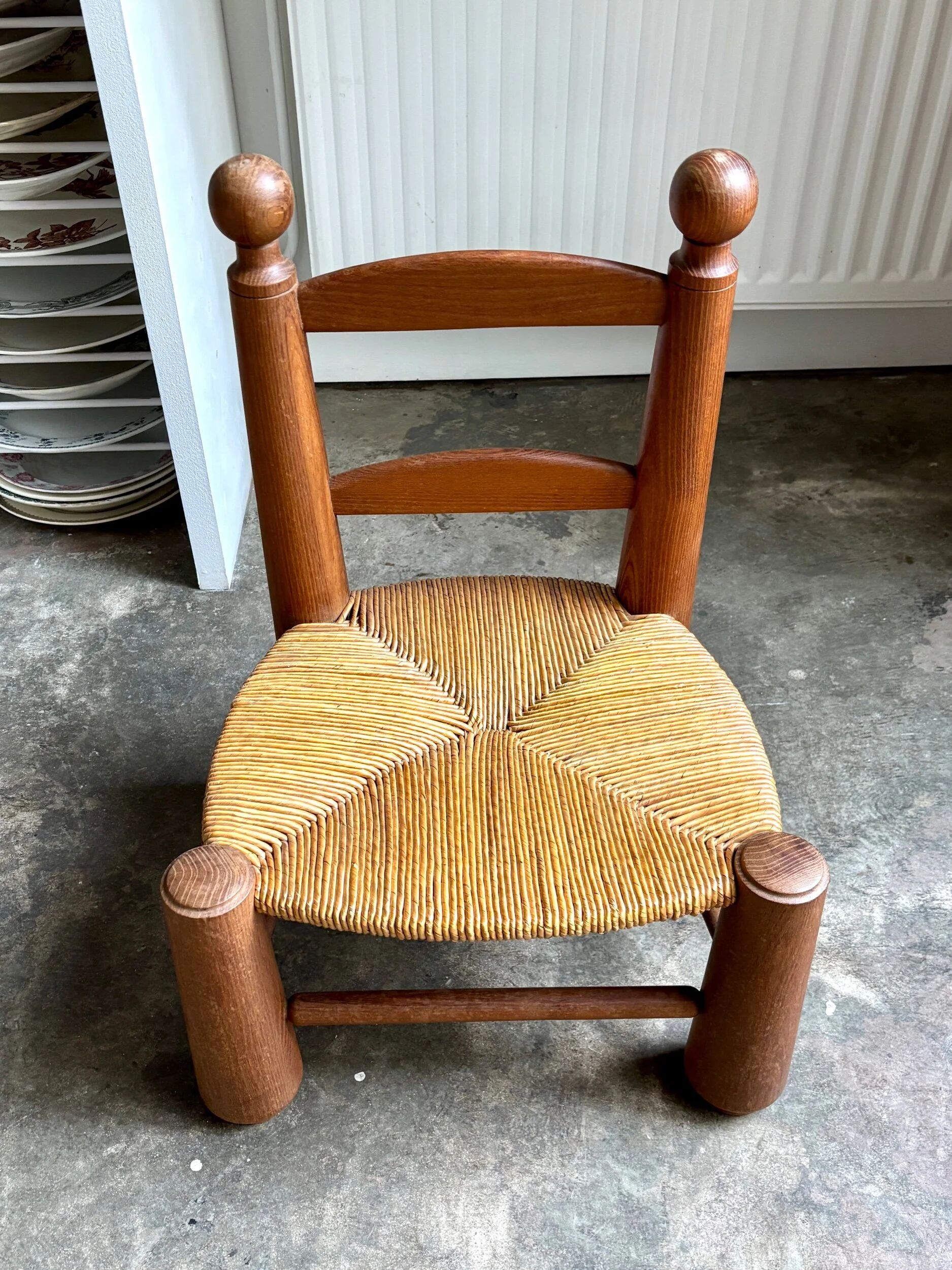 Brutalist low chair in dark wood and straw no. 3