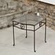 Petite table d'appoint en fer forgé et verre fumé