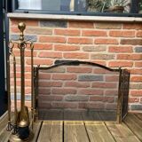 Old brass fireplace set and its fire screen grille
