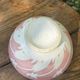 Old footed bowl in earthenware with pink decoration and defects.