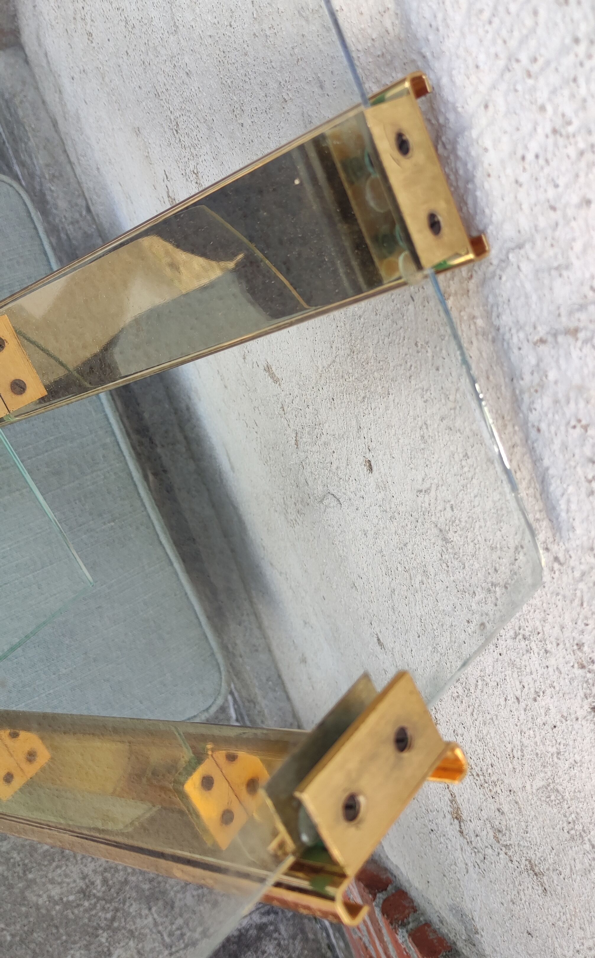 Wall shelf in gilded metal and glass/1980s