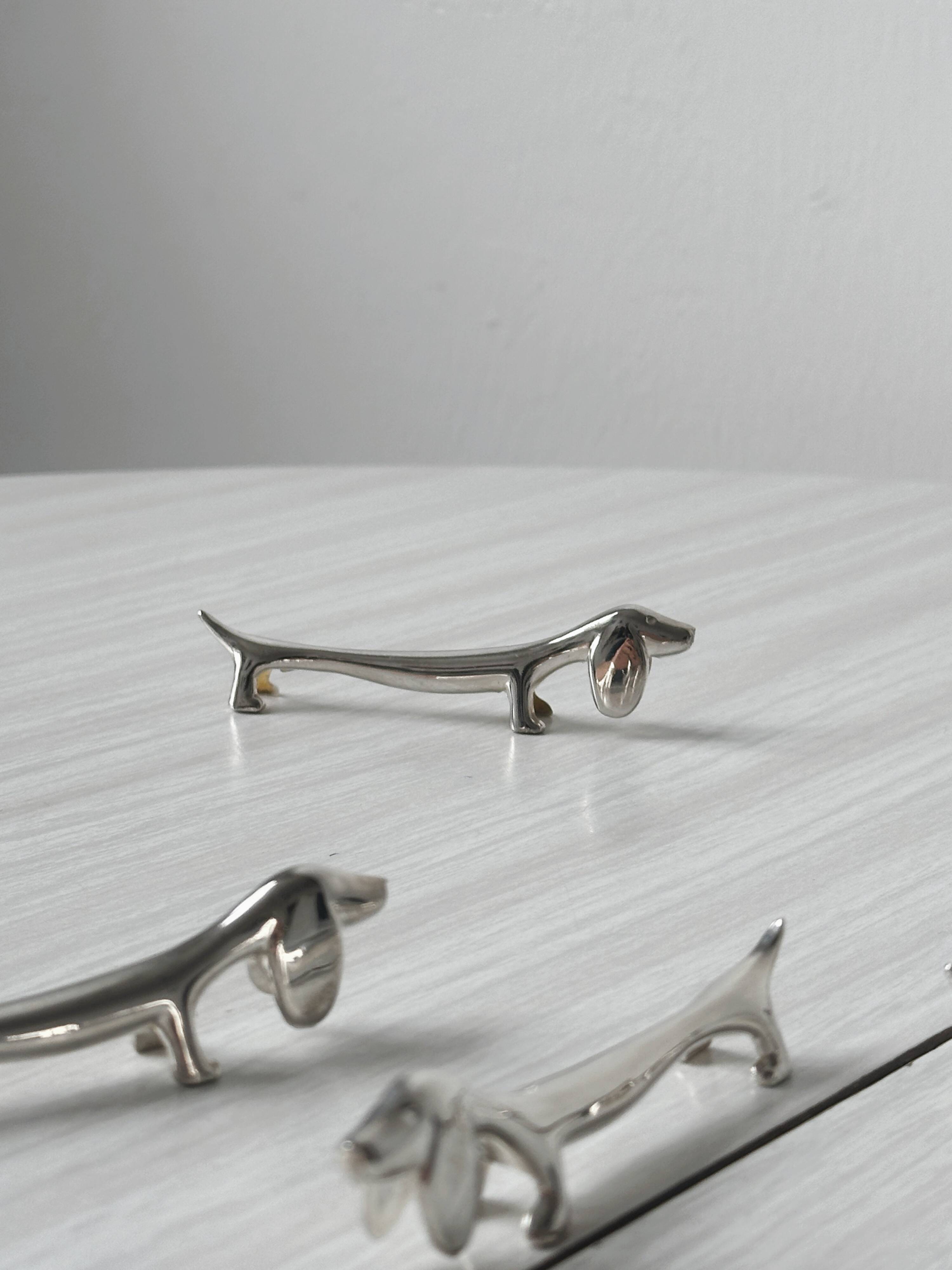 Metal dachshund dog knife holder.