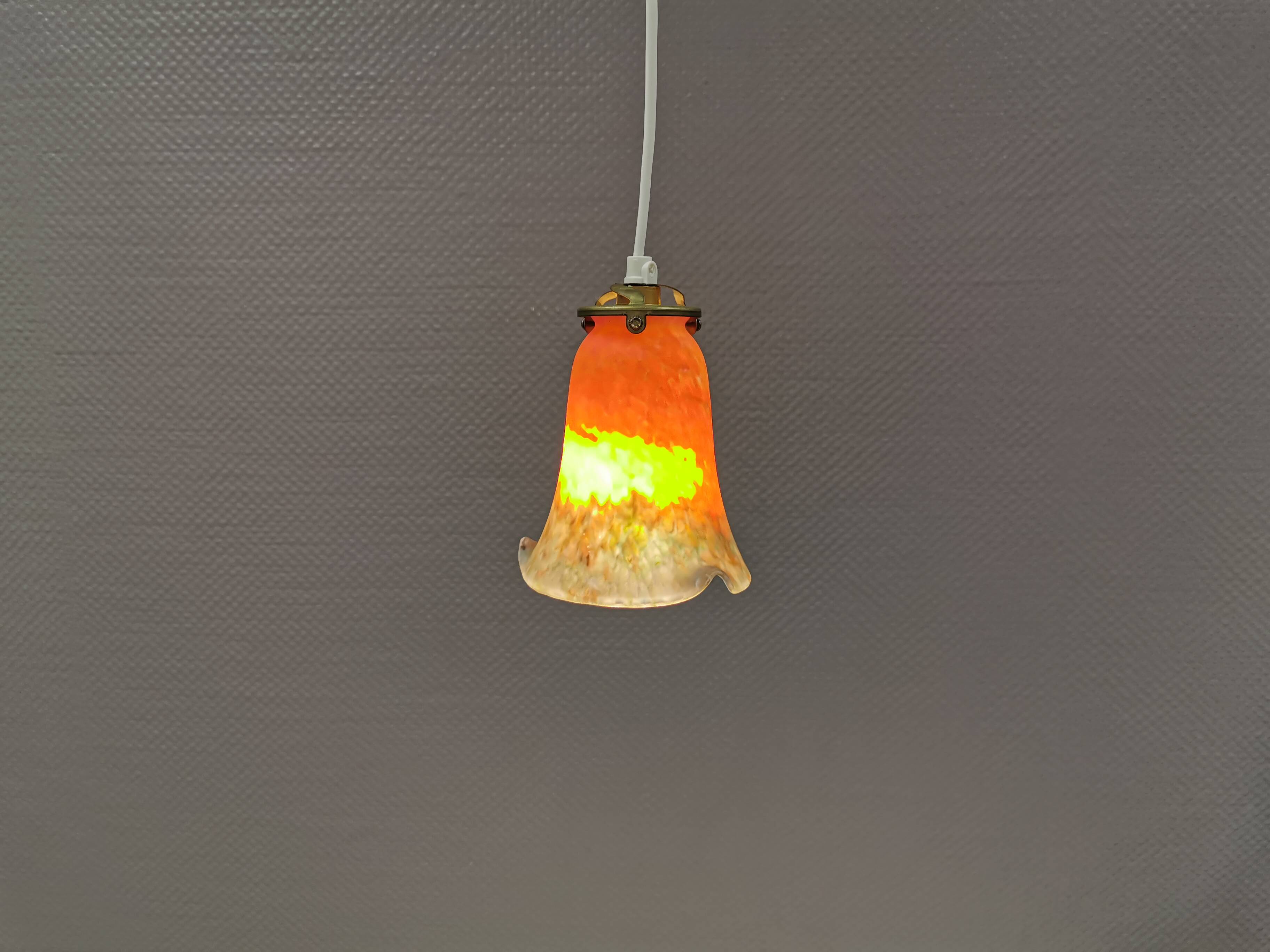 Small, beautiful hanging lamp in Art Deco style with brass top.