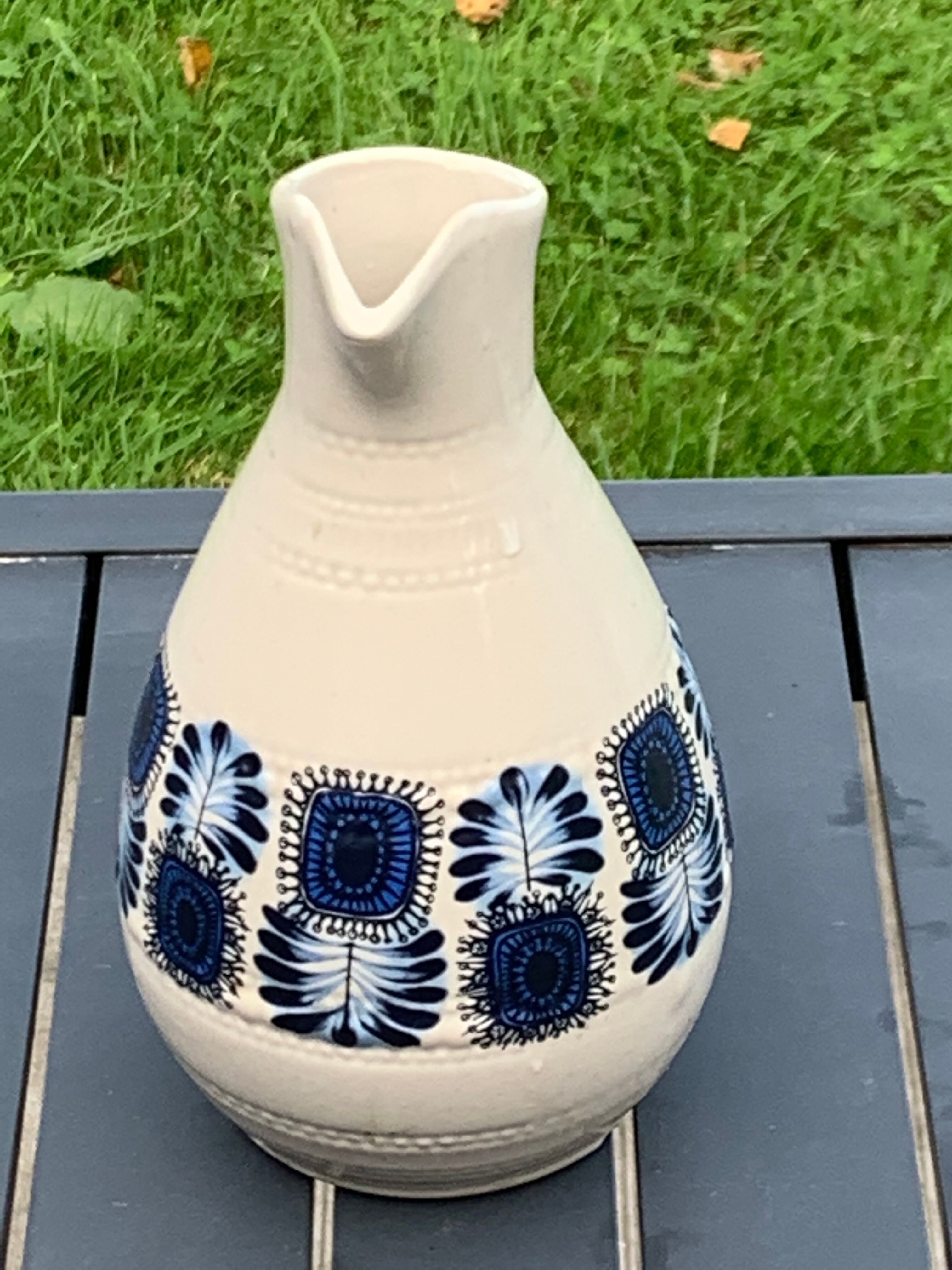 Enamelled sandstone carafe with a nice pattern of vintage blue flowers and 1970 design