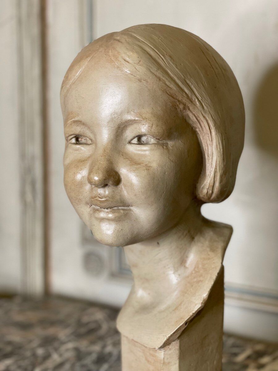 Plaster bust, young girl, monogram and date.