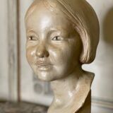 Plaster bust, young girl, monogram and date.