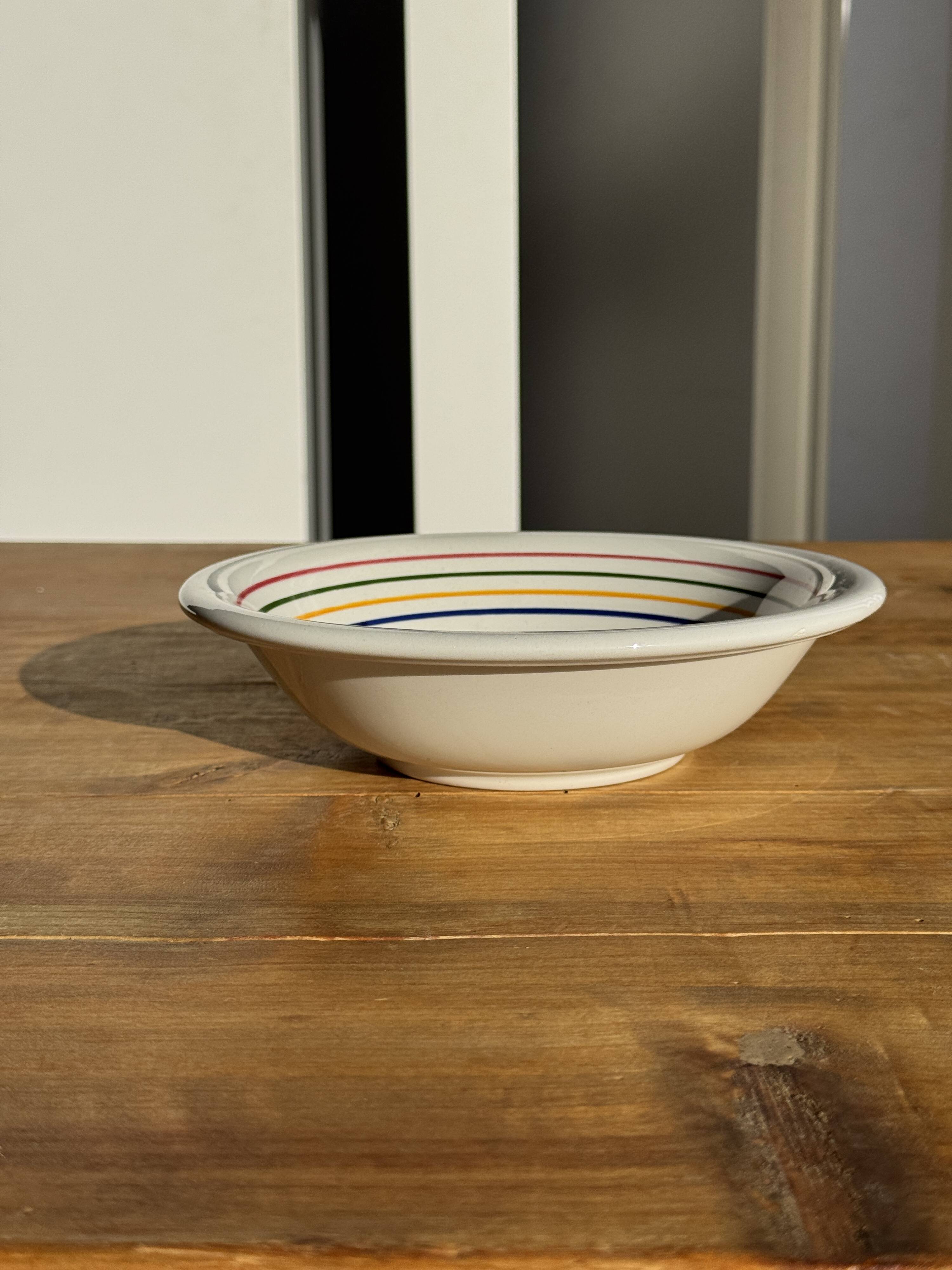 Small earthenware bowl from Italy, white with brown, green, and orange trim, D24.5.