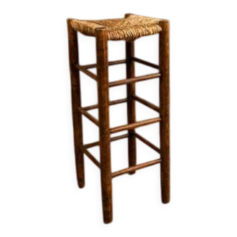 Vintage rustic style bar stool made of solid wood with a straw seat.