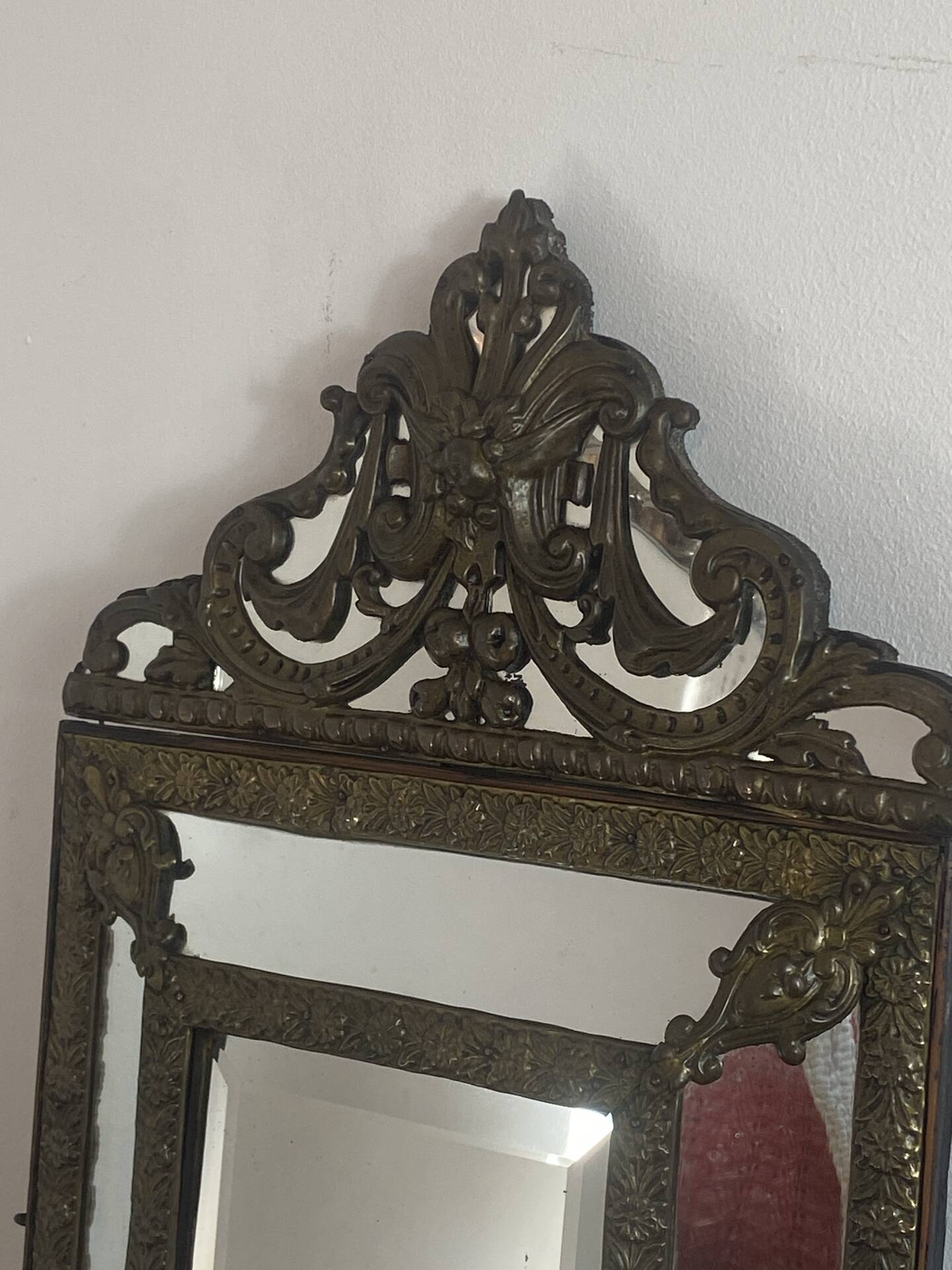 Mirror with brass repoussé frame