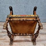 Renaissance armchair in carved walnut with lion head decoration