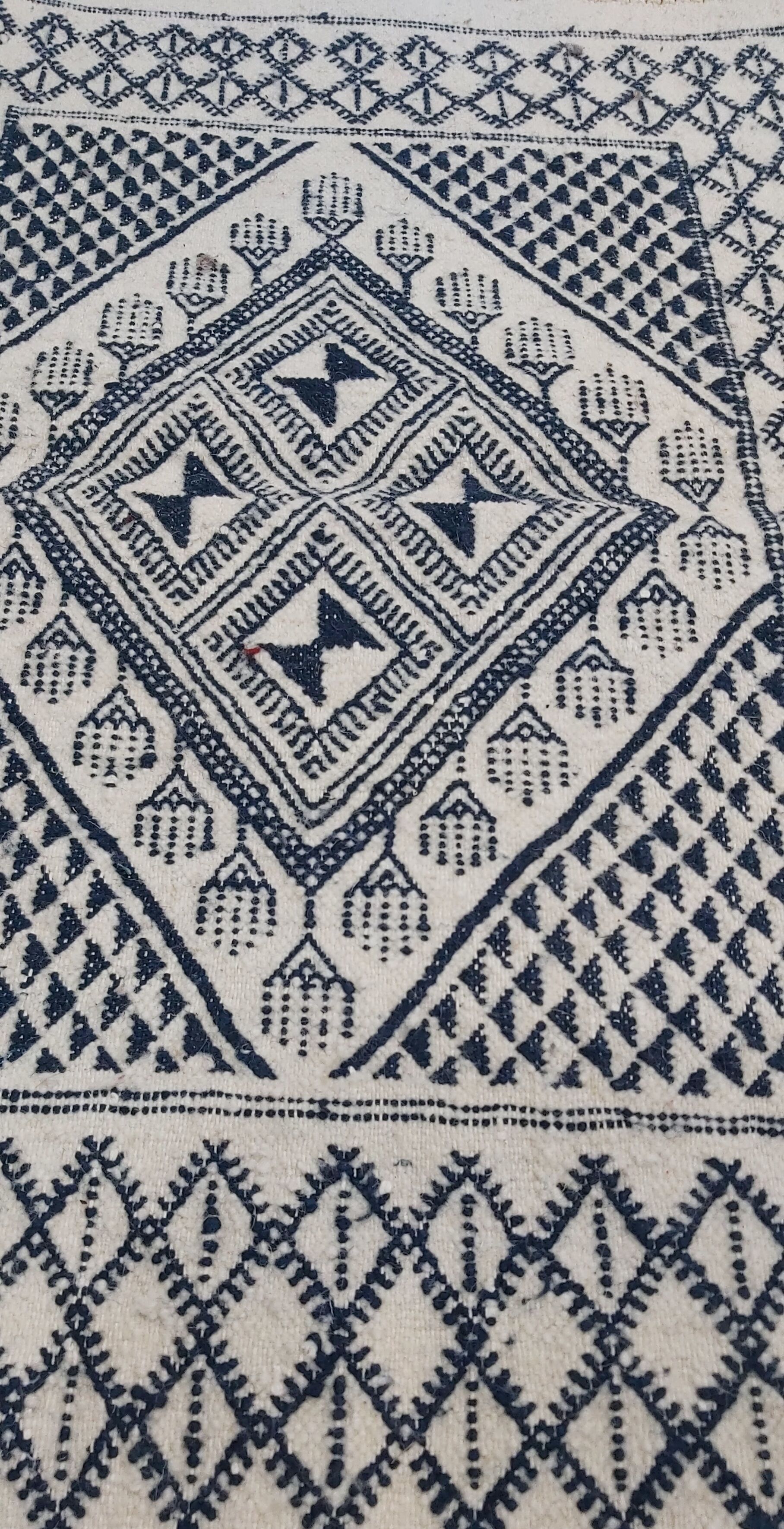 Traditional white and blue hand-woven wool carpet