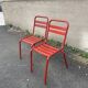2 red metal Tolix-style chairs, France 1950