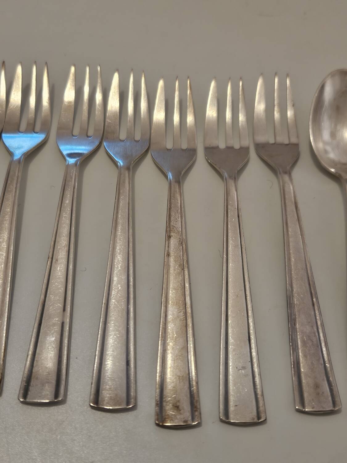 Set of silver dessert spoons and forks