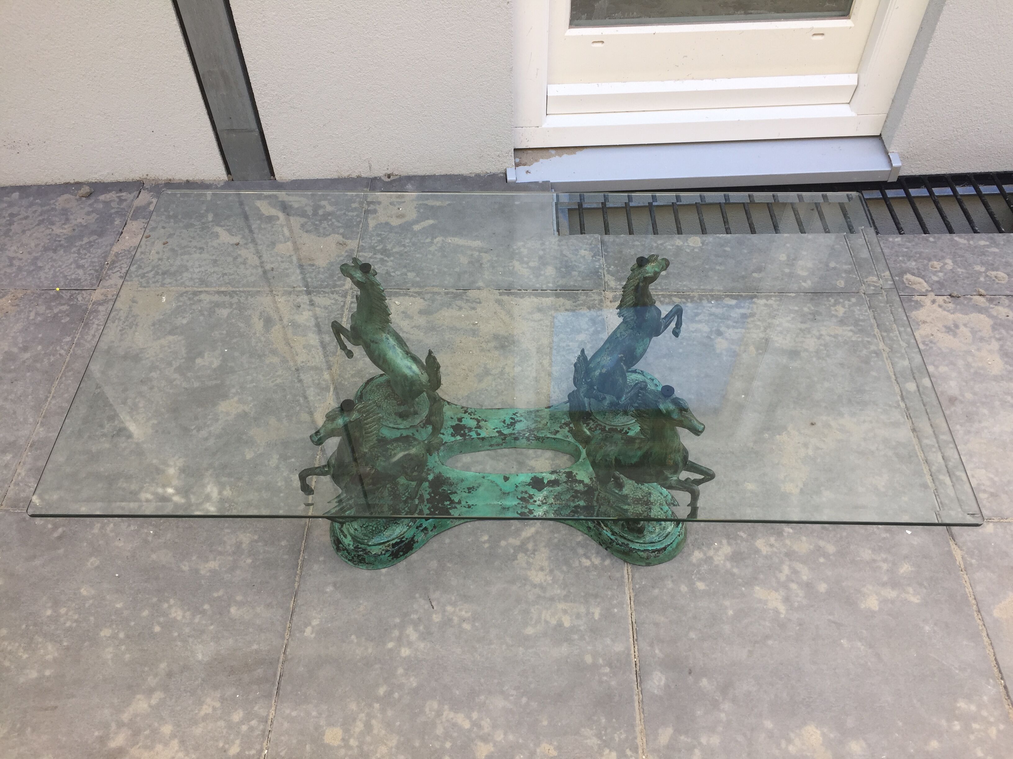 Coffee table with glass plate and bronze horses