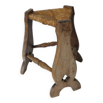 old wooden and straw tripod stool