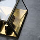 Wall sconce in brass and glass