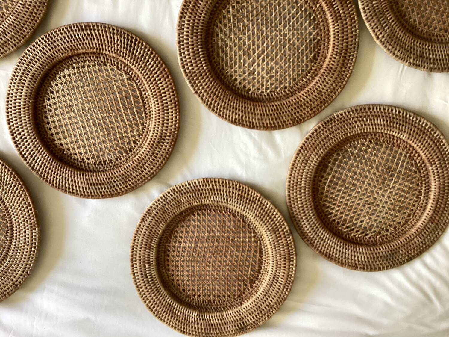 Set of round woven rattan and canework coasters