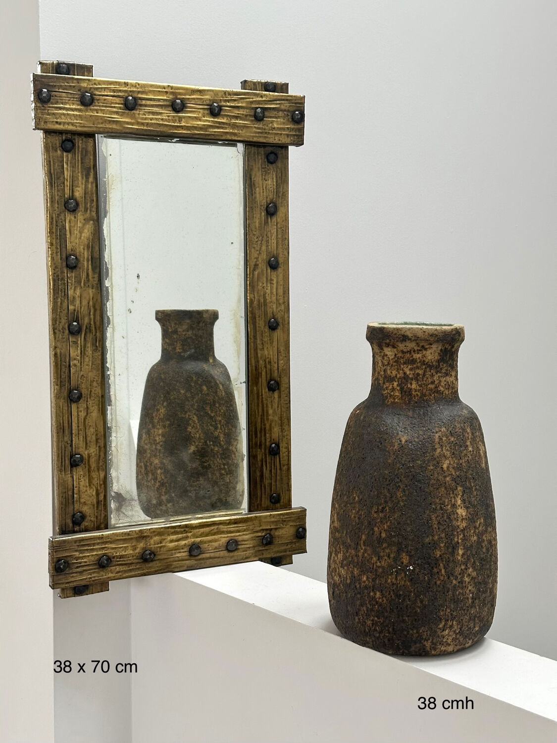 Brutalist mirror with a hammered copper and brass frame.