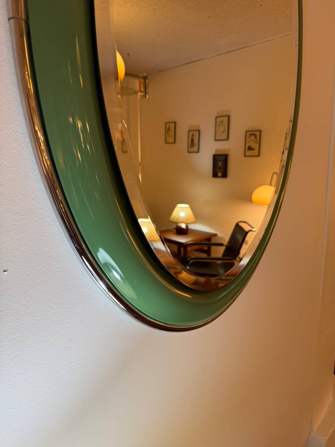 Vintage oval mirror with English green lacquered curved frame and chrome surround
