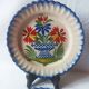 Pair of antique plates in popular earthenware with a floral basket decoration on the edge.