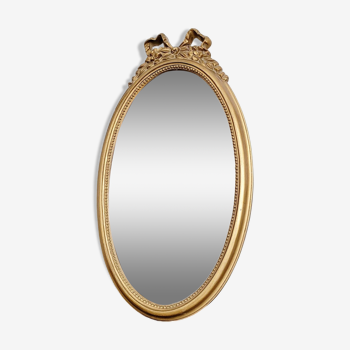 Golden oval mirror