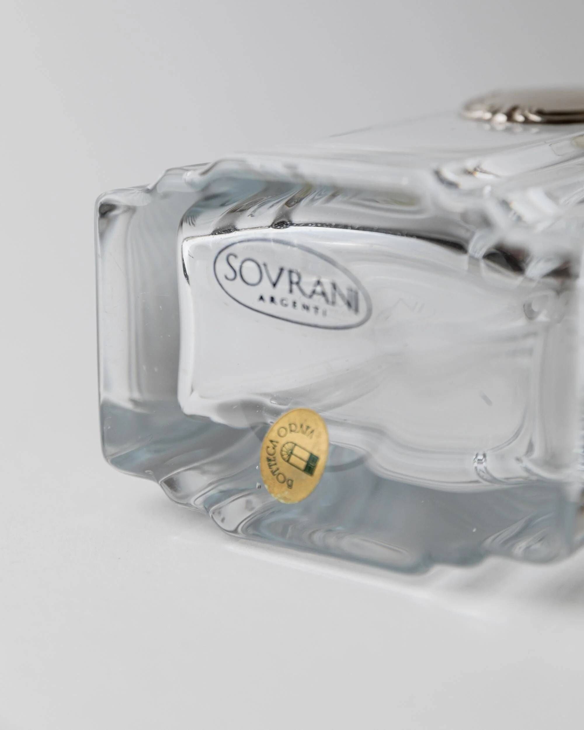 Vintage glass decanter from the 1980s, transparent glass with a silver plate and spherical stopper.