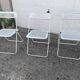 Set of three folding chairs with perforated metal.