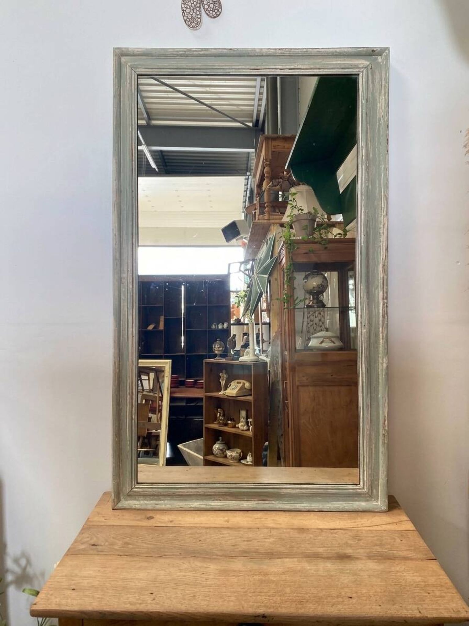 Antique mirror with a green and white patina.