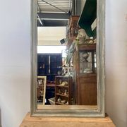 Antique mirror with a green and white patina.