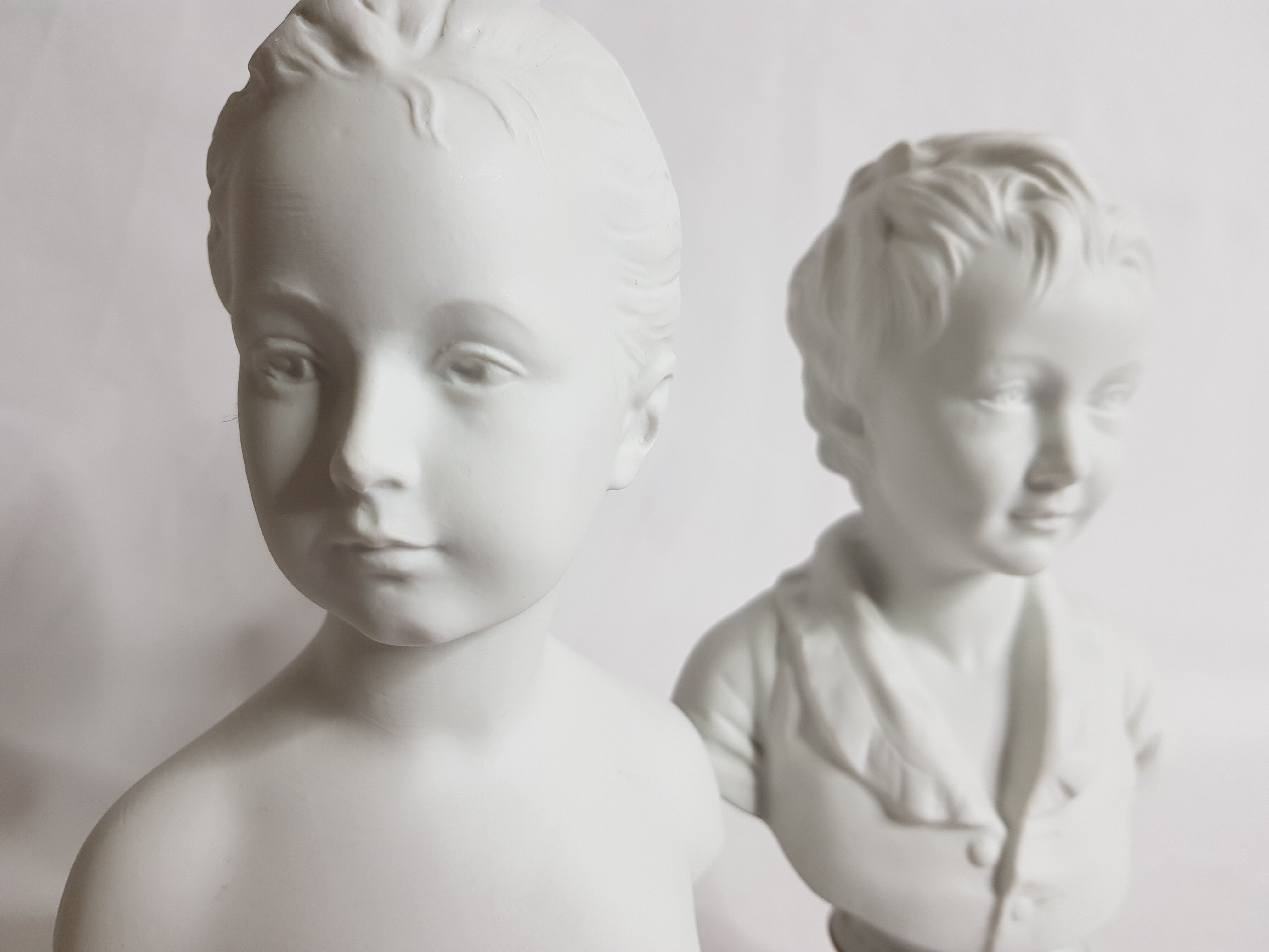 Porcelain biscuit busts by Camille Tharaud, children Louise and Alexandre Brongniart after Houdon