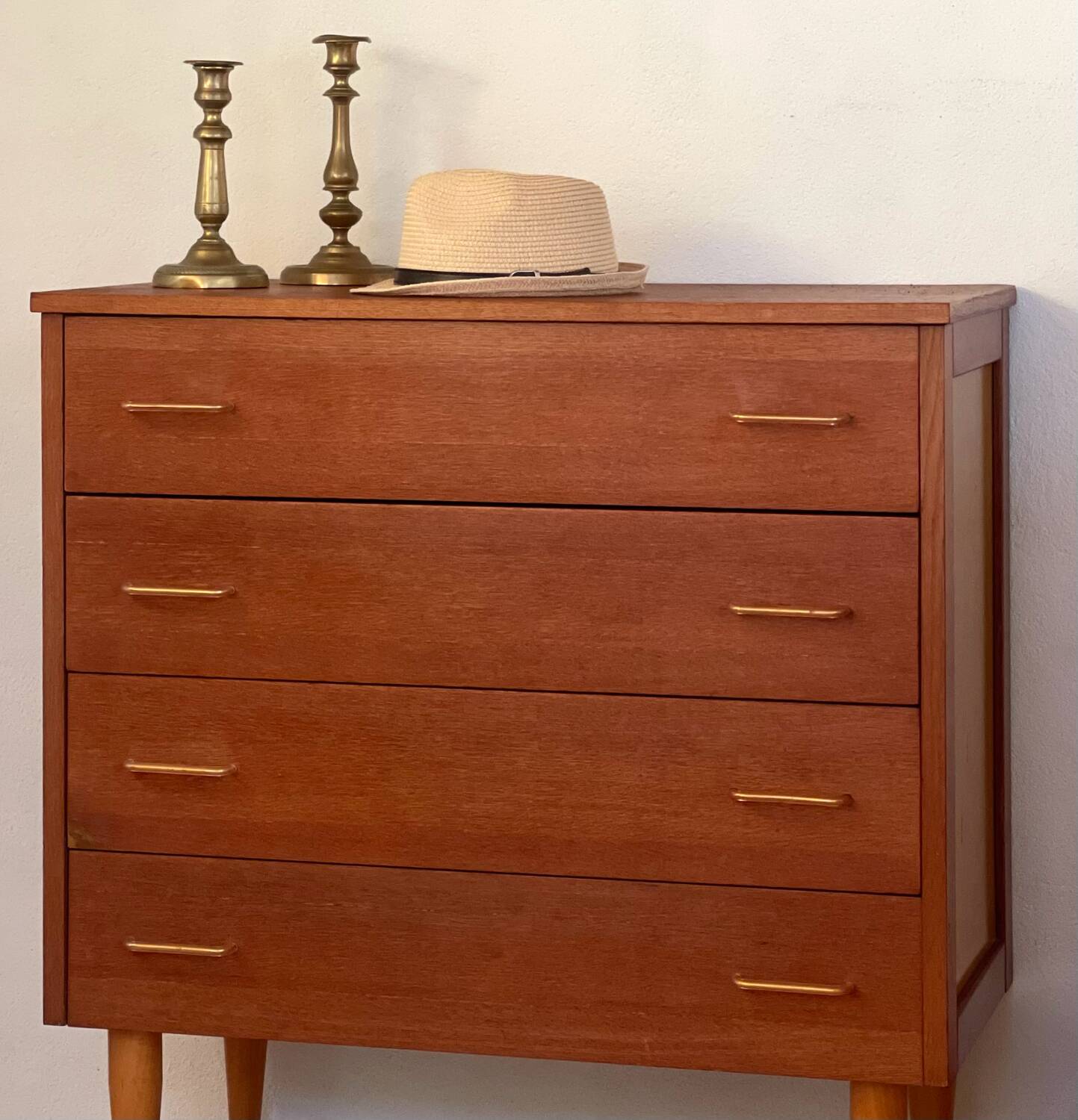 Vintage 1960s chest of drawers with covered handles.
