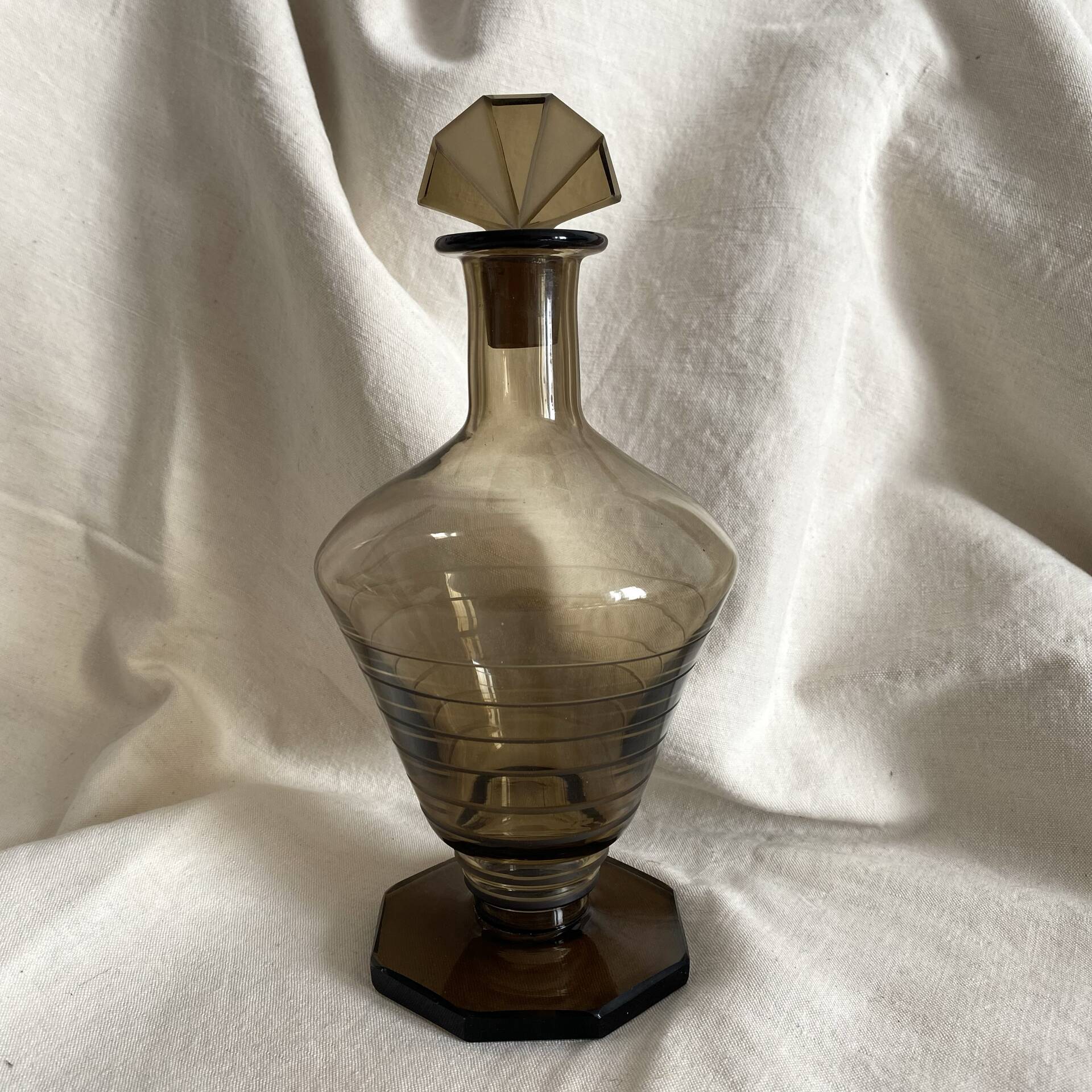 Art Deco smoked glass carafe with fan-shaped stopper.