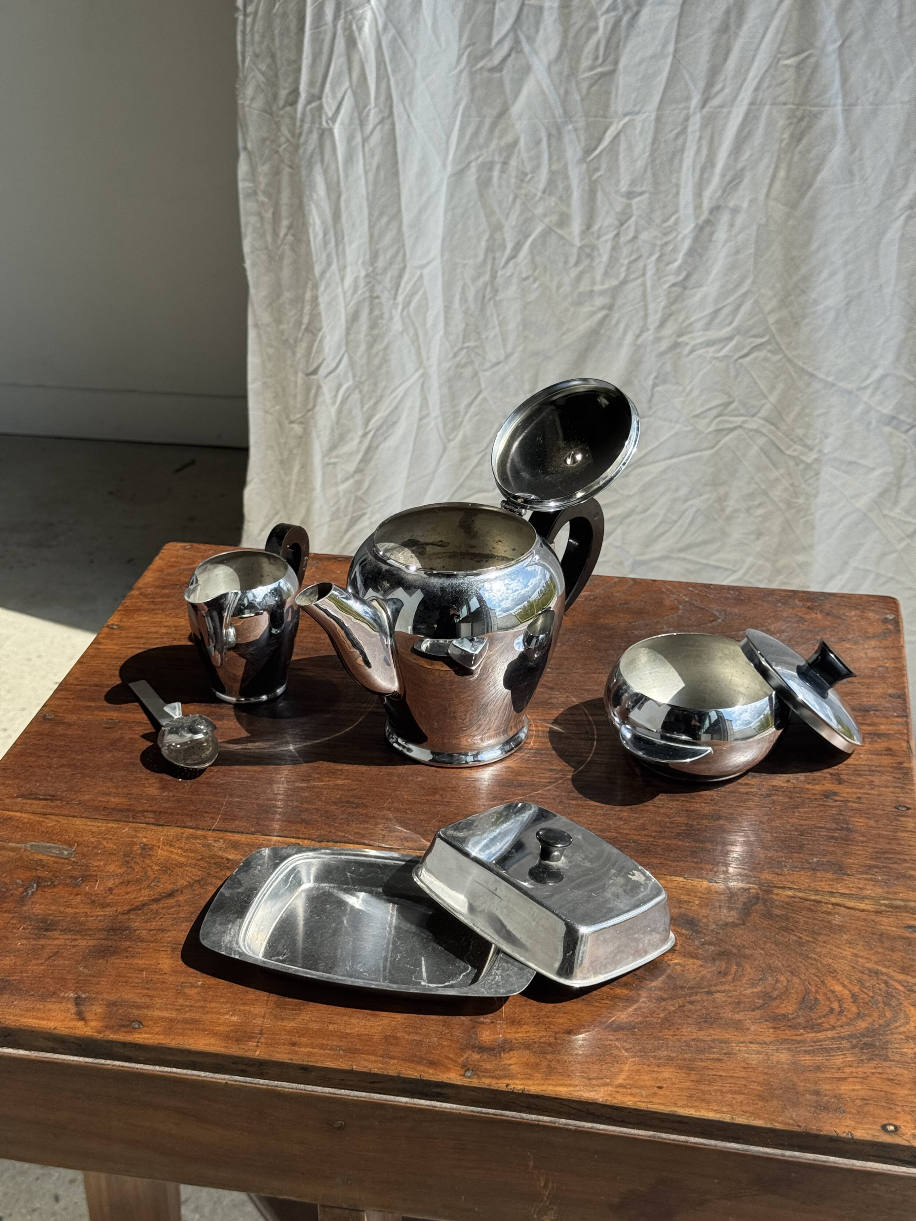 Tea set including teapot, milk jug, sugar bowl and butter dish