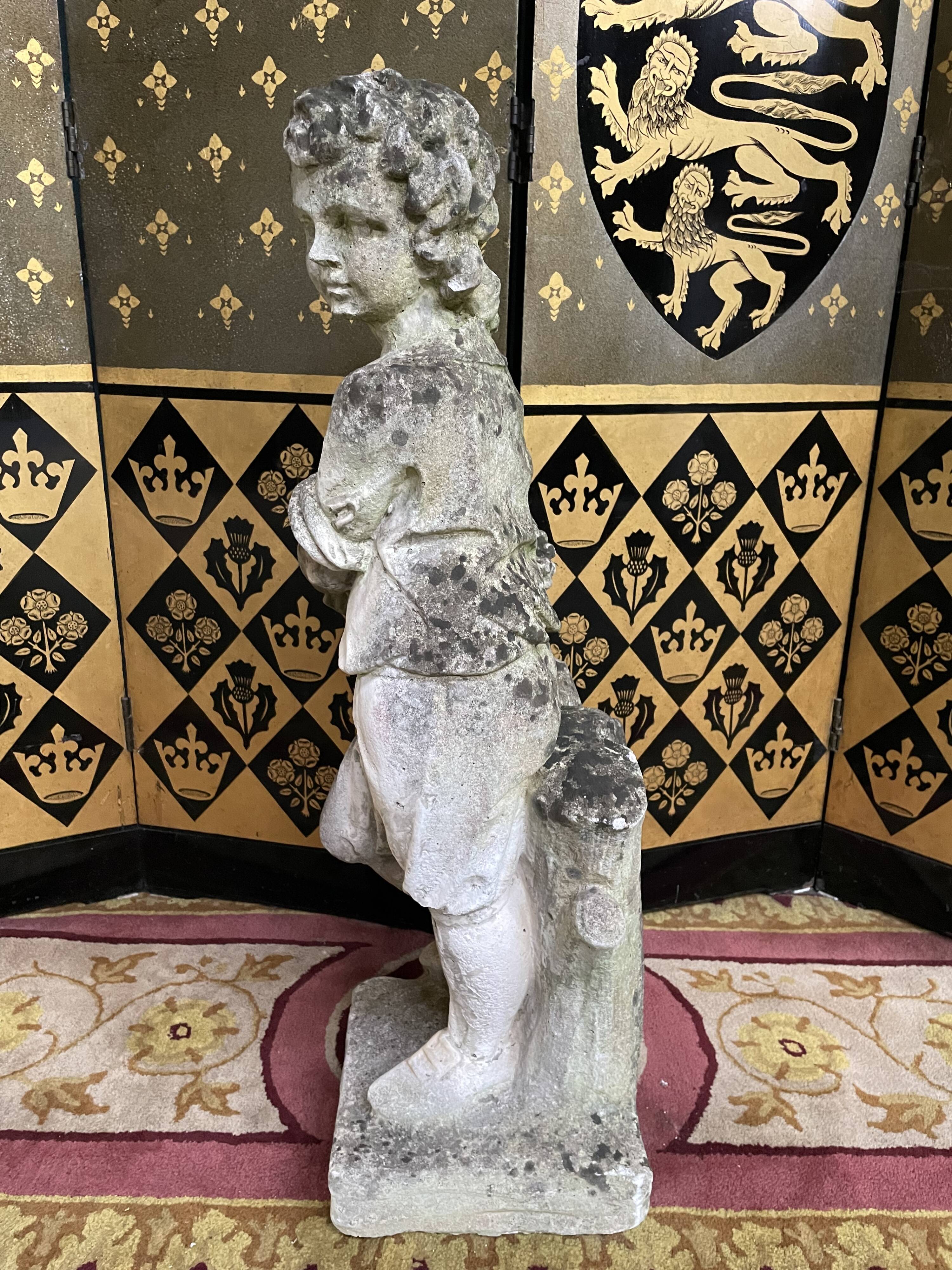 Stone garden statue to the child