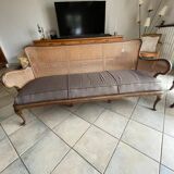 Sofa with backrest and cane armrests