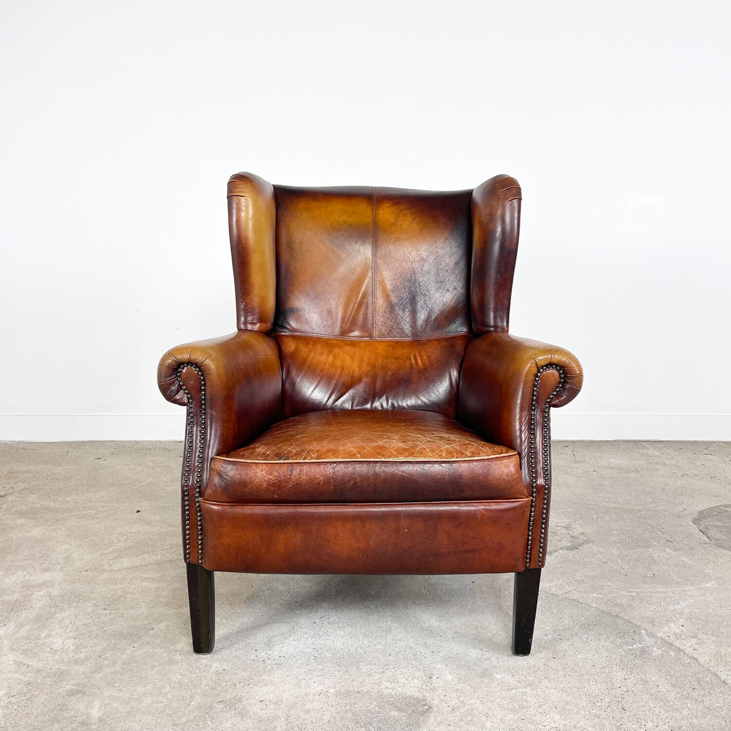 Vintage sheep leather wingback armchair Goor