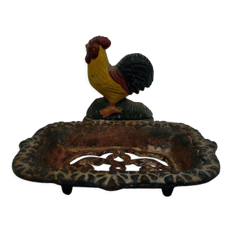 Cast iron soap holder with rooster decoration.