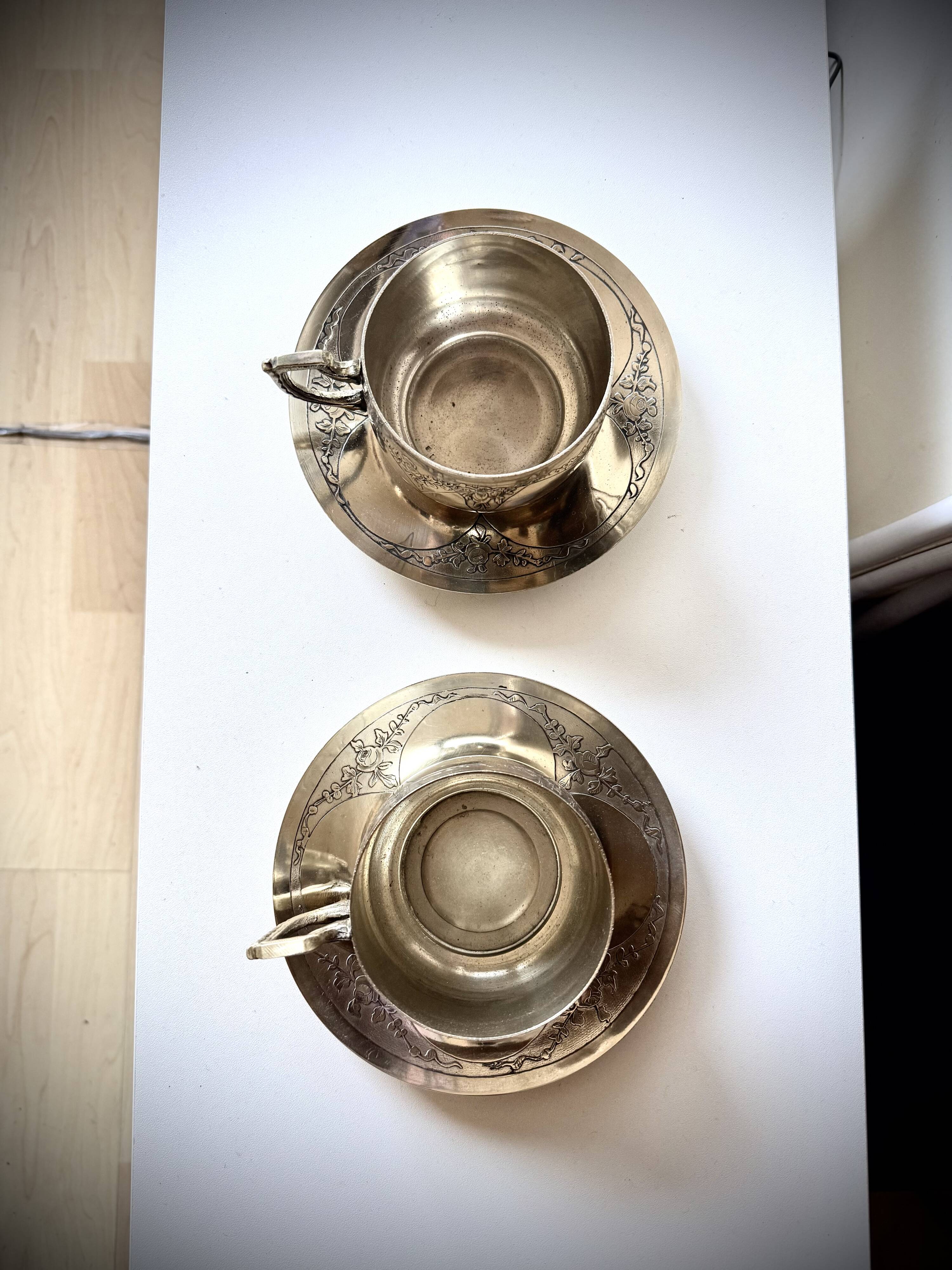 Set of 2 cups with silver-plated saucers, 19th century.