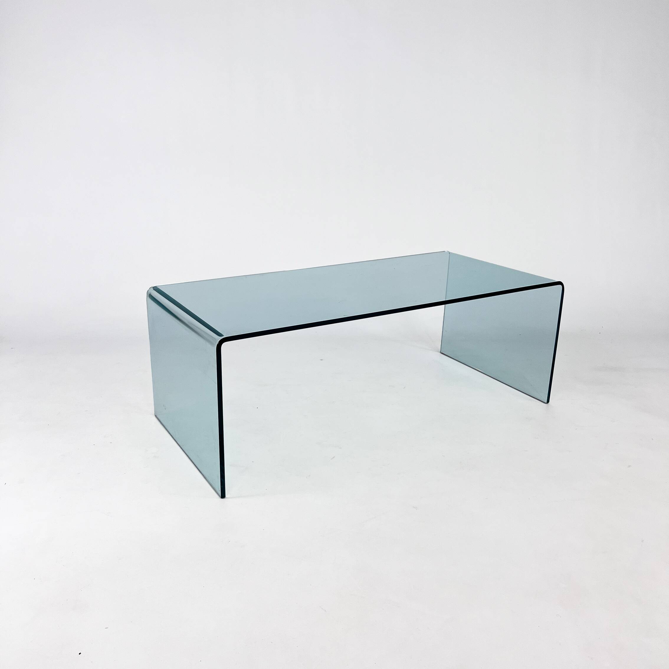 Postmodern coffee table made entirely of glass. Modernist and bitches minimalist look.