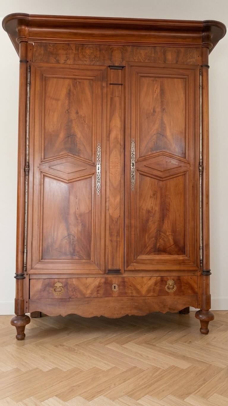 Large antique wooden wardrobe with drawer.